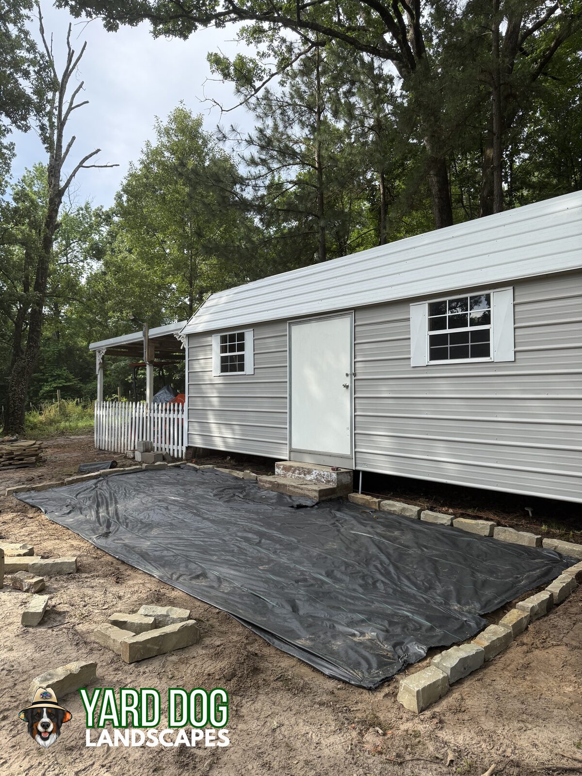Landscape fabric and stone border set for a flagstone patio in East Texas