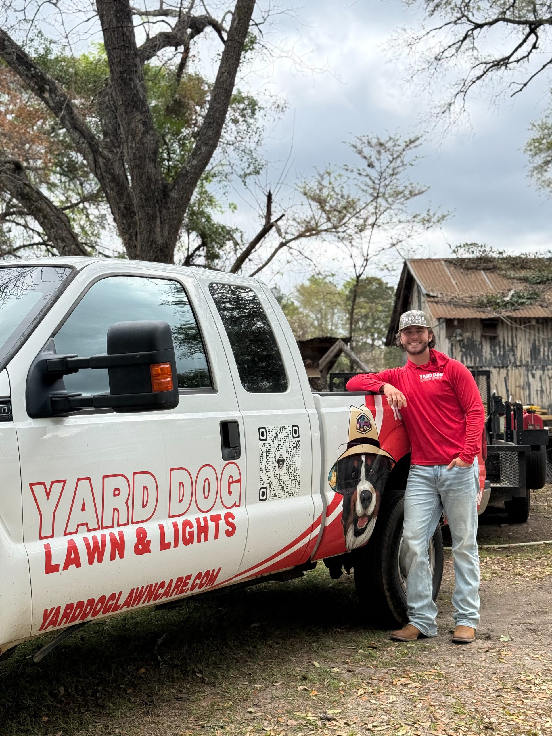 Yard Dog crew member with the company truck and shop dog