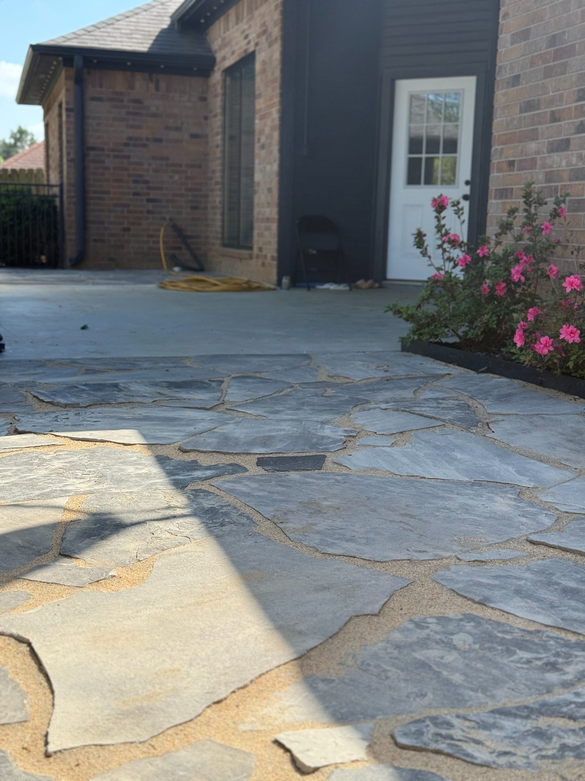 Flagstone patio with blooming pink azaleas