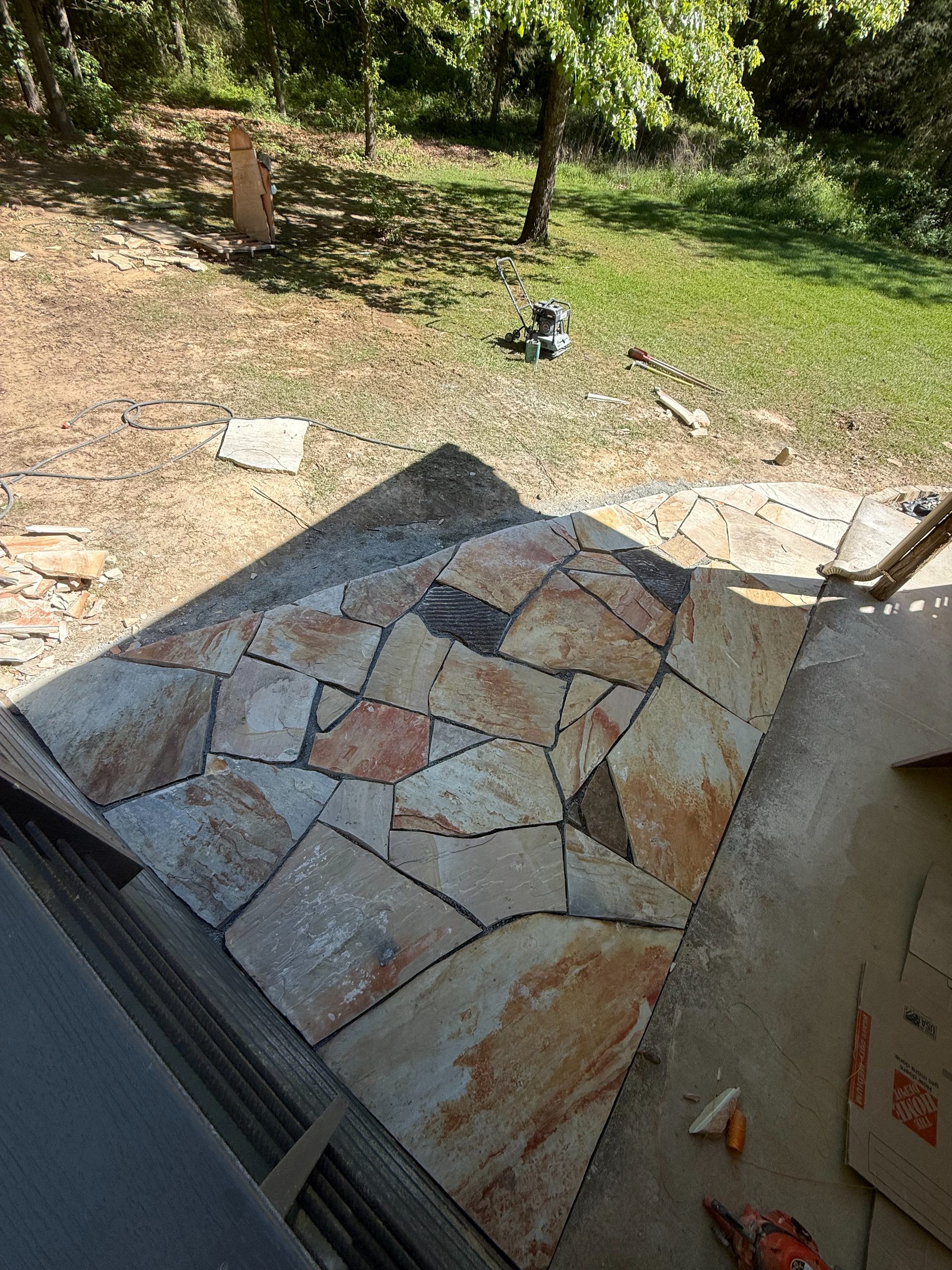 Custom flagstone patio install in a backyard