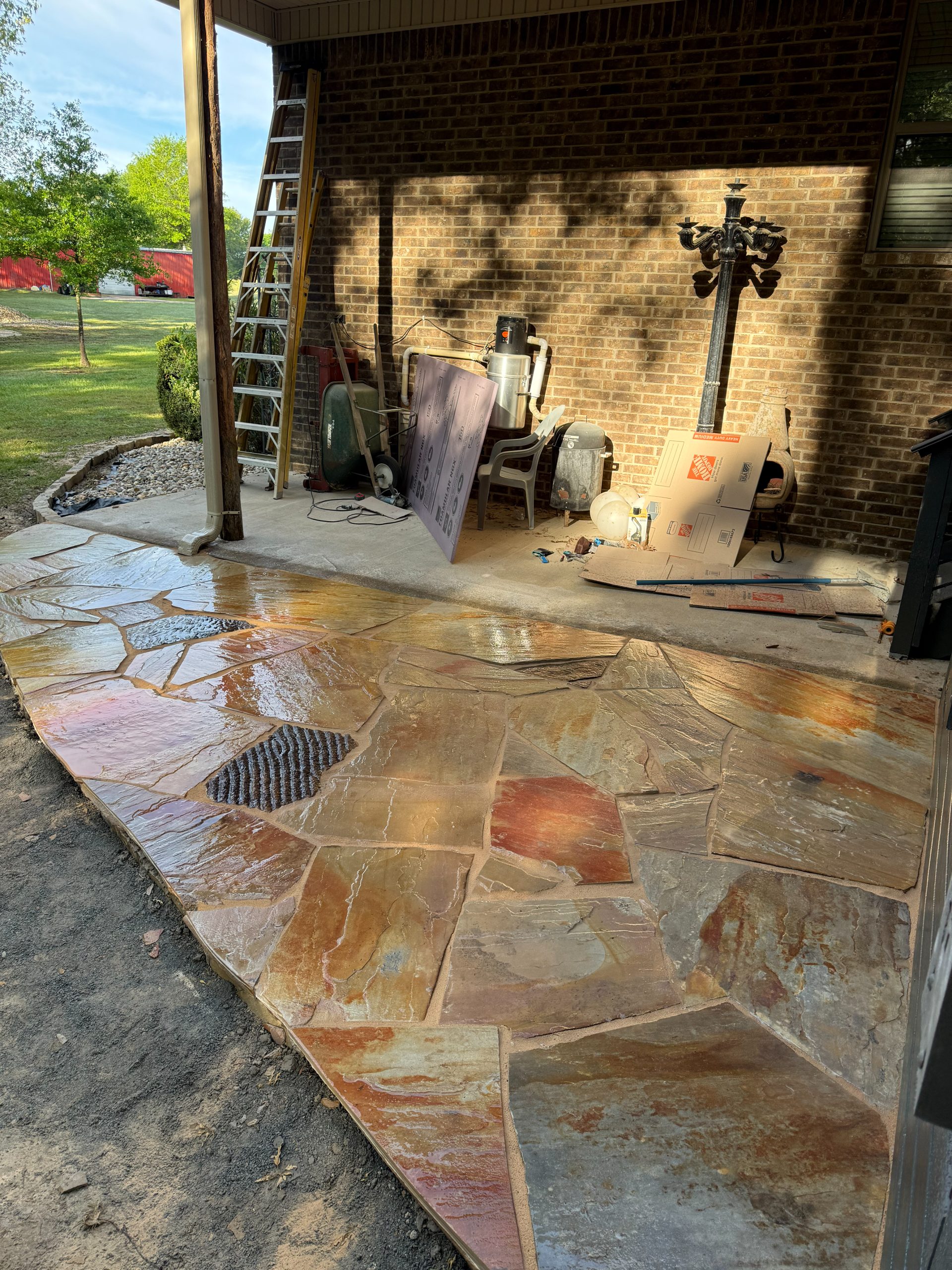Warm-toned flagstone patio at a brick home