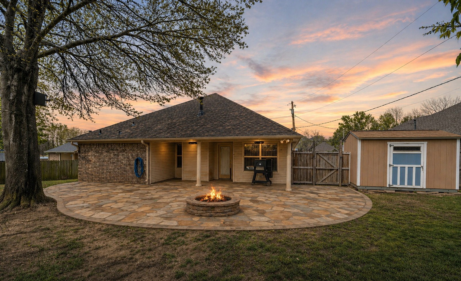 Yard Dog Landscapes design rendering for a backyard flagstone patio with a custom fire pit and seating area