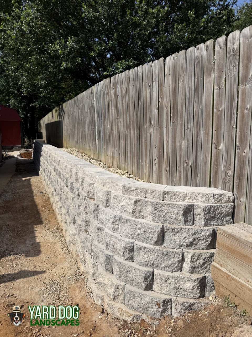 Finished segmental block retaining wall replacing an old wood wall in East Texas
