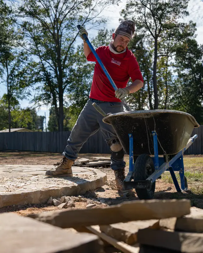 Mixing mortar in a wheelbarrow, Kilgore, TX