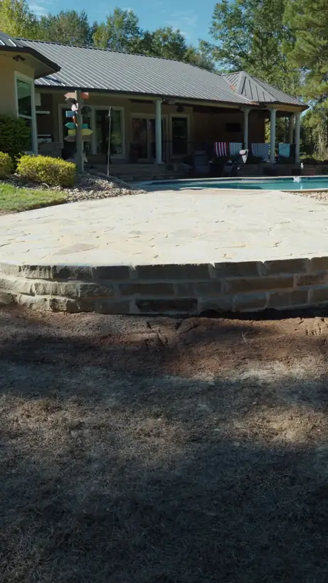 Flagstone patio with a raised chopped stone border by the pool, Hallsville, TX