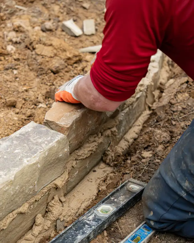 Leveling the chopped stone border, Hallsville, TX