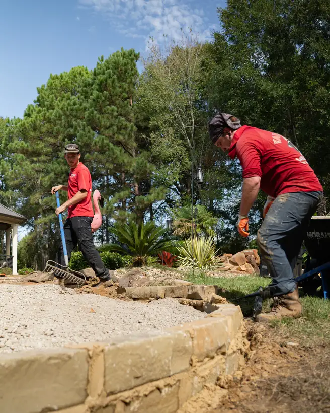 Raking the limestone base inside the border, Hallsville, TX