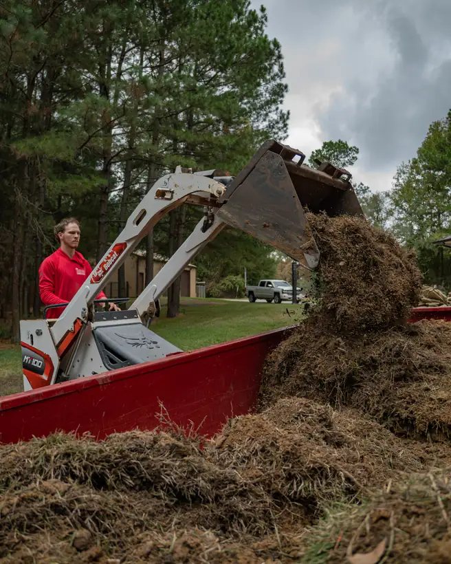 Loading old turf and dirt into the dump trailer, Hallsville, TX