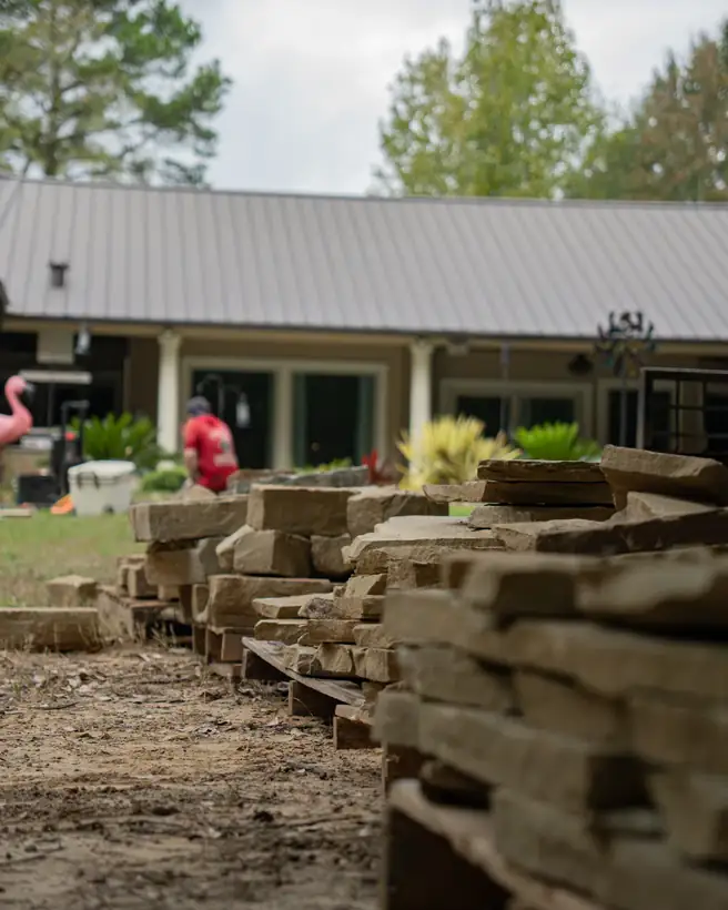 Chopped stone staged on pallets beside the house, Hallsville, TX