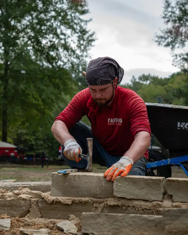 Tapping a border stone into place, Hallsville, TX