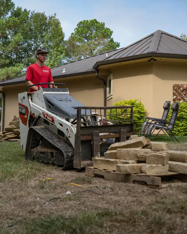Hauling chopped stone across the yard on the track loader, Hallsville, TX