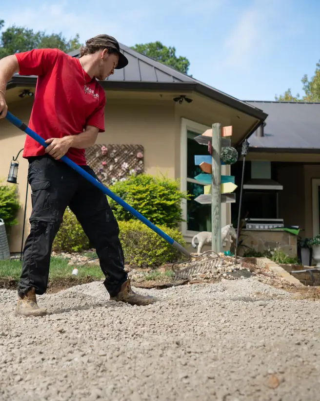 Raking out the crushed limestone base, Hallsville, TX