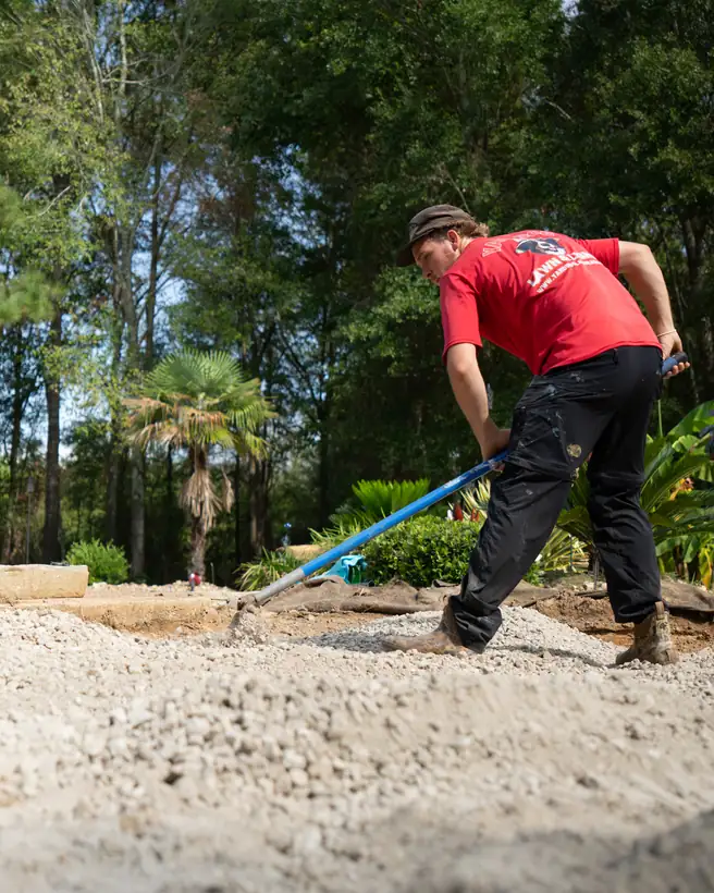Spreading the limestone base inside the border, Hallsville, TX