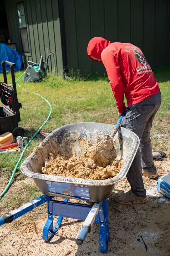 Mixing mortar for the stone borders, Kilgore, TX