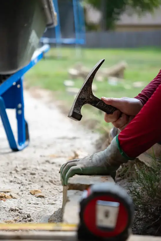 Shaping chopped stone with a hammer and chisel, Kilgore, TX