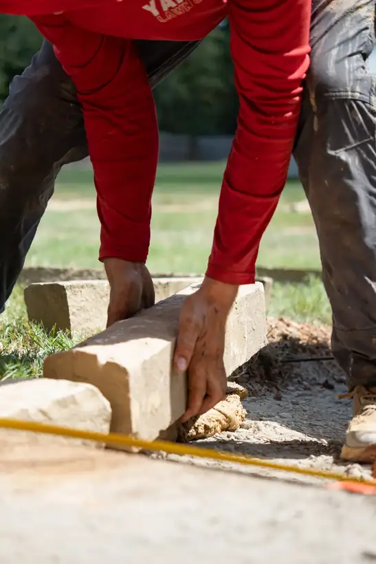 Setting a border stone by hand, Kilgore, TX