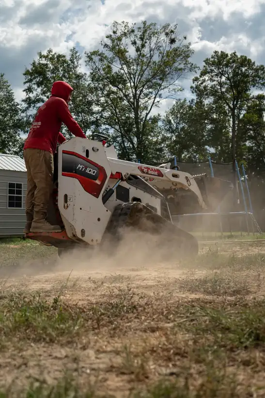 Loader spreading base, dust flying, Kilgore, TX