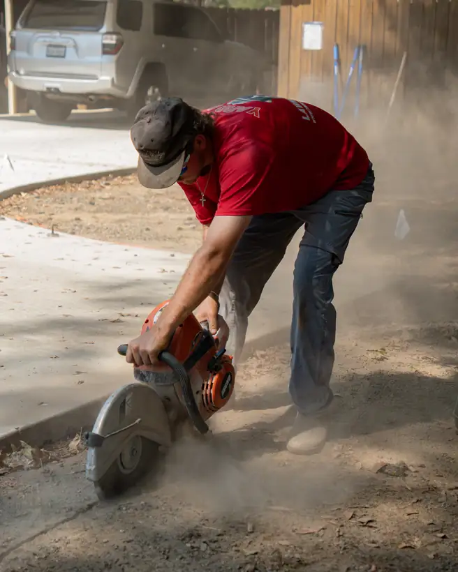 Saw-cutting concrete for the sprinkler line, Longview, TX