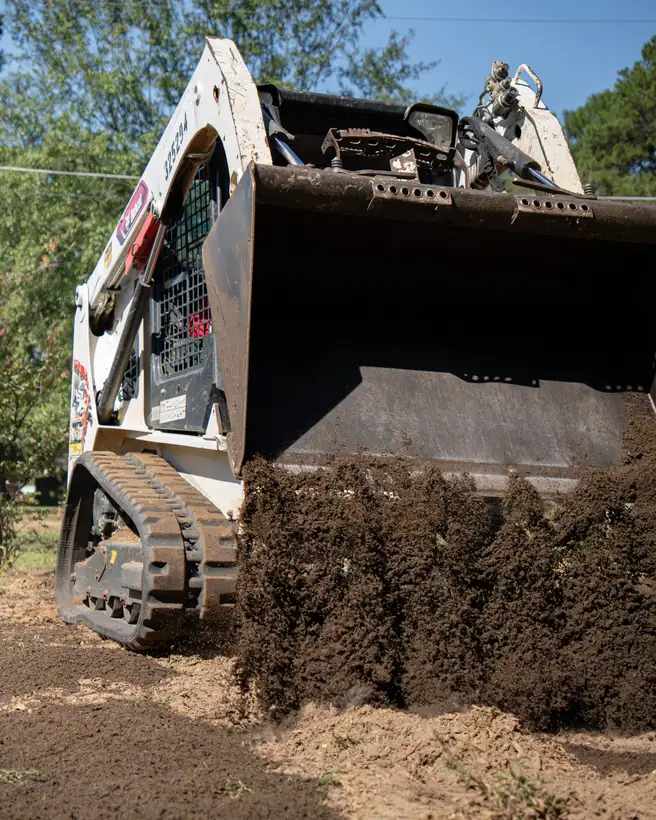 Dumping topsoil across the yard, Longview, TX