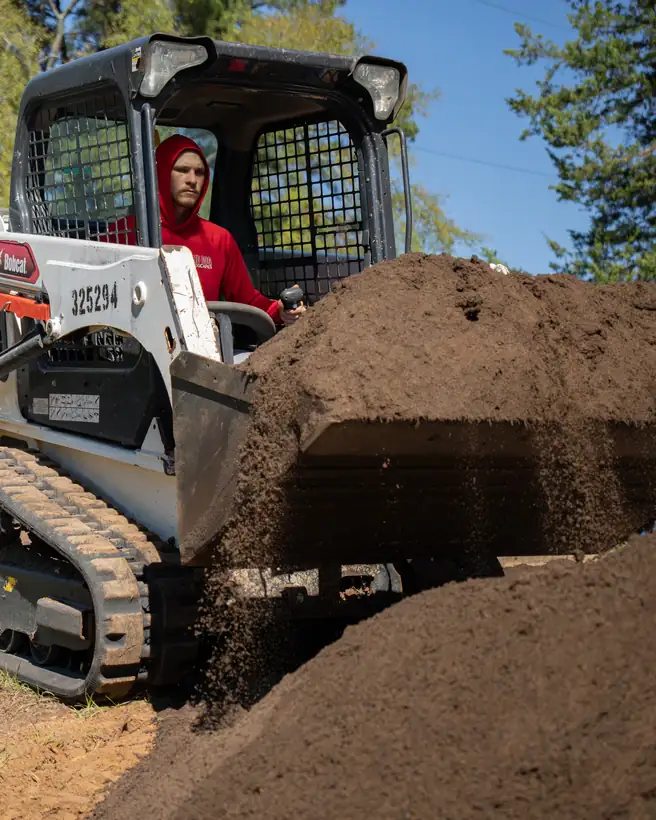 Spreading a pile of topsoil, Longview, TX