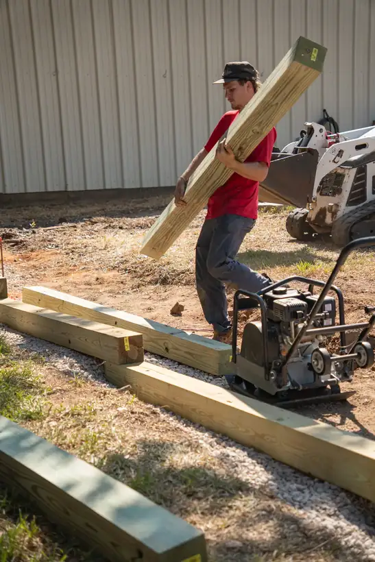 Setting the next course of timbers, White Oak, TX