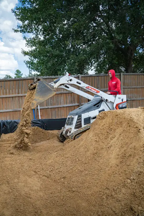 Loader dumping fill inside the wall, White Oak, TX