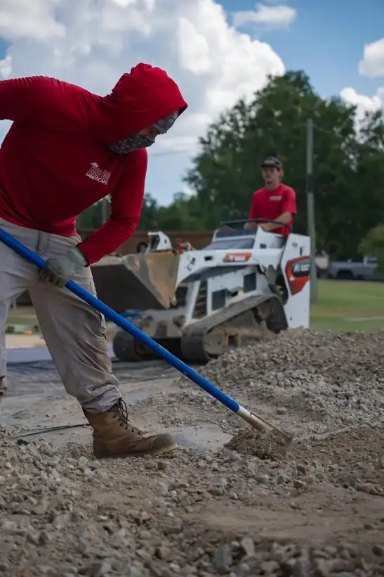 Raking gravel across the pad, White Oak, TX