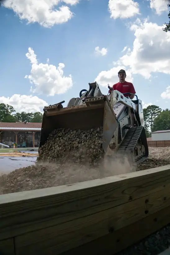 Gravel pouring from the bucket, White Oak, TX