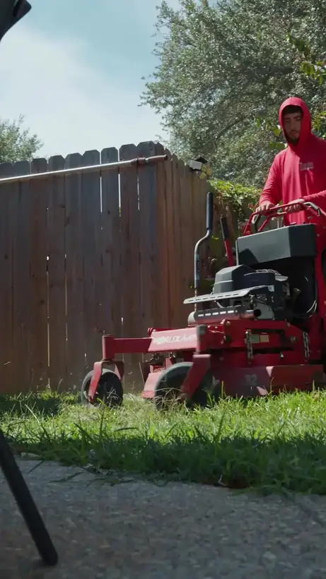 Zero-turn mowing a backyard, East Texas