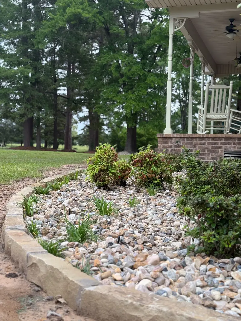Curved river rock bed with sandstone edging, East Texas