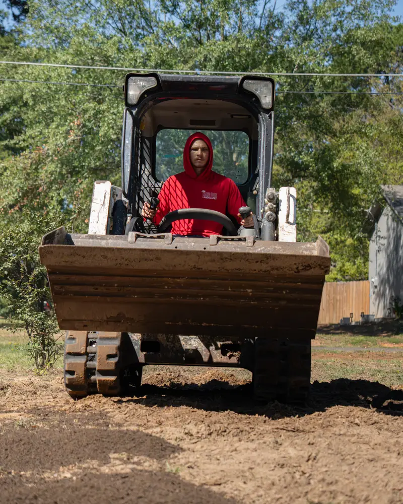 Track loader bringing in topsoil, Longview, TX