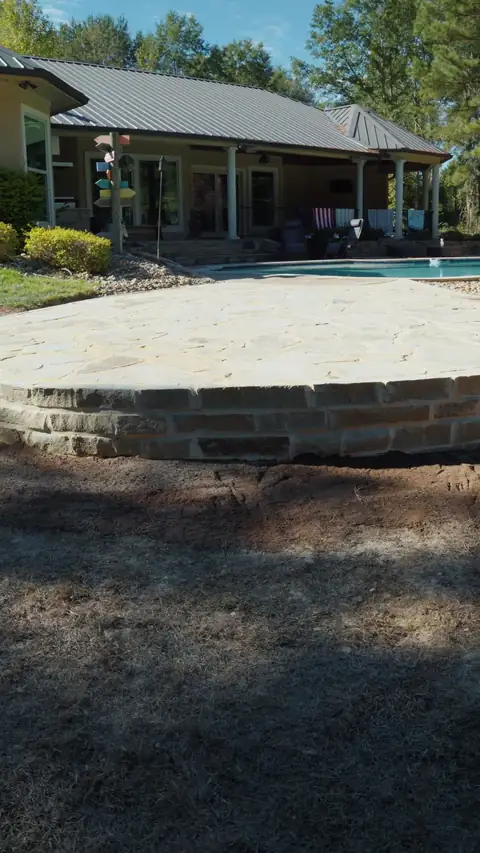 Flagstone patio with a raised chopped stone border by the pool, Hallsville, TX